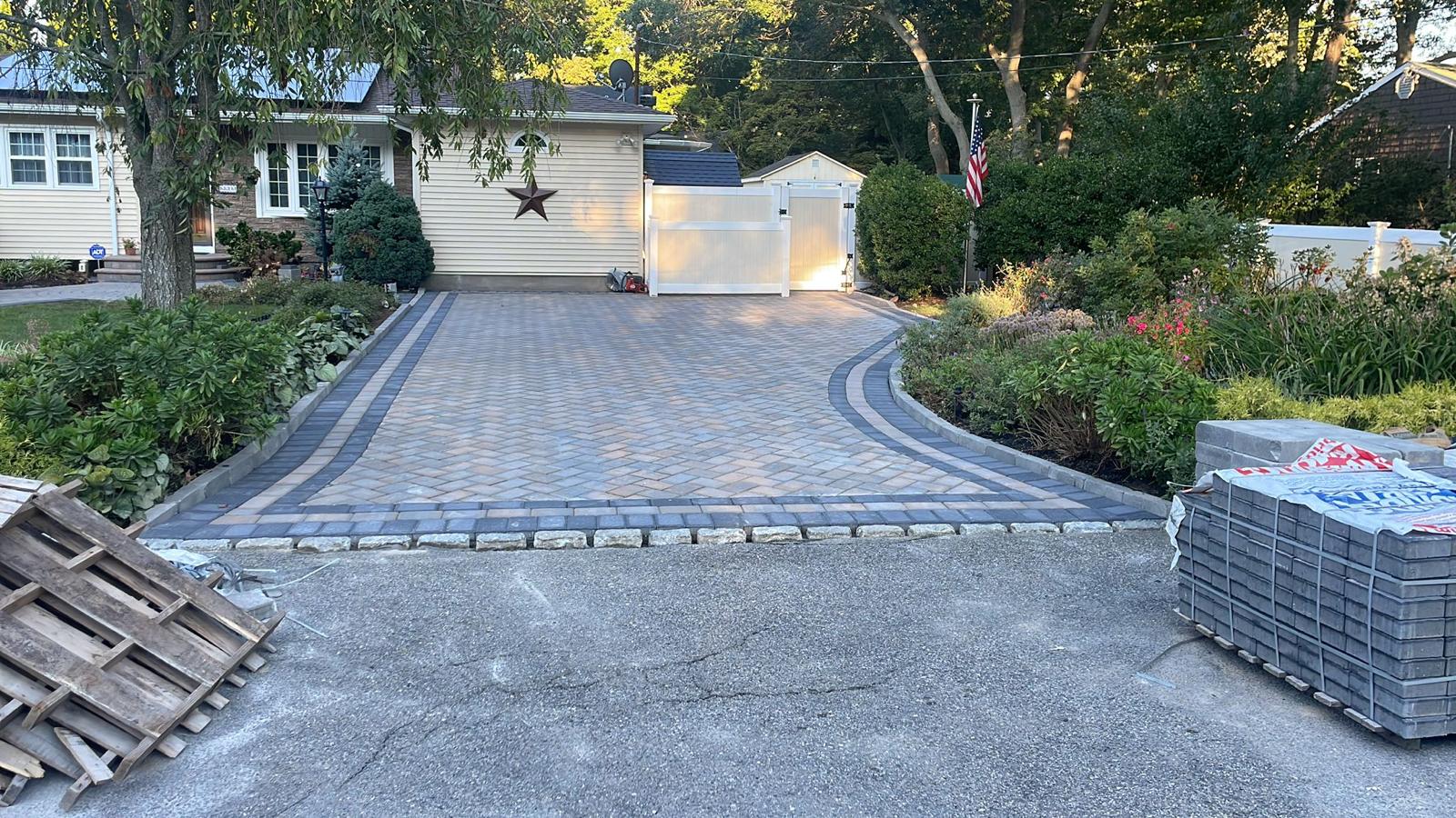 Wide paver driveway with decorative banding and Belgian block edging
